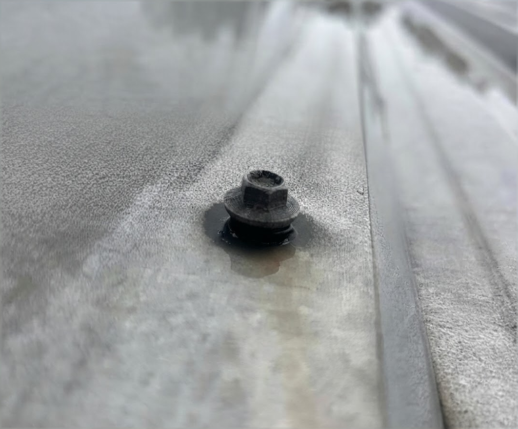 Close-up of a fastener and seal on a commercial metal roof