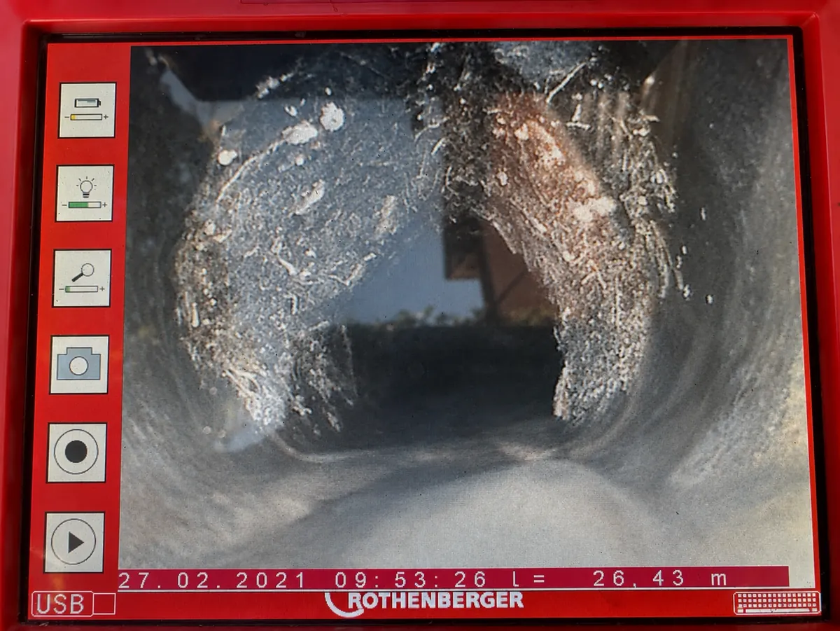 CCTV drain camera screen showing tree root intrusion inside a pipe